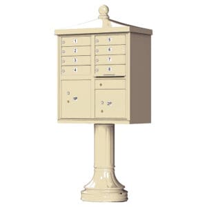Beige pedestal mailbox with multiple compartments.