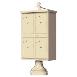 Cream-colored pedestal mailbox with four compartments.